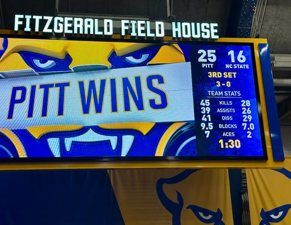 Photo of a scoreboard graphic that says "PITT WINS" at Fitzgerald Field House from the volleyball team's victory over NC State